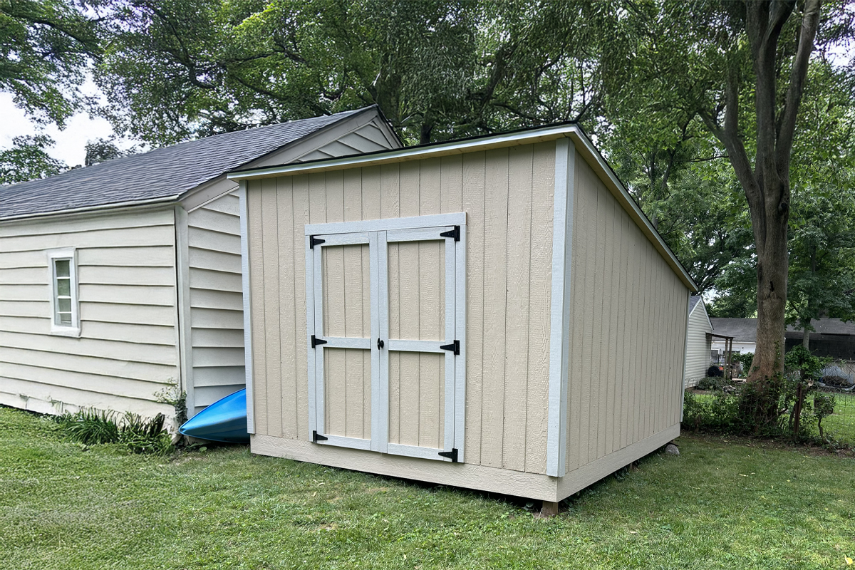 Custom studio with Hardie siding, sliding bard door, and transom windows